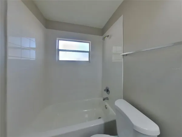 a bathroom with a toilet and bathtub