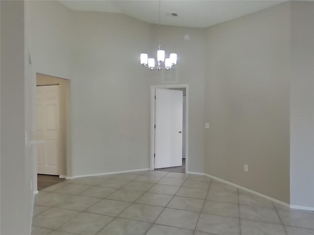 Undisclosed Address Brandon, FL 33511 - Photo 4 of 18 a view of an empty room with a chandelier fan