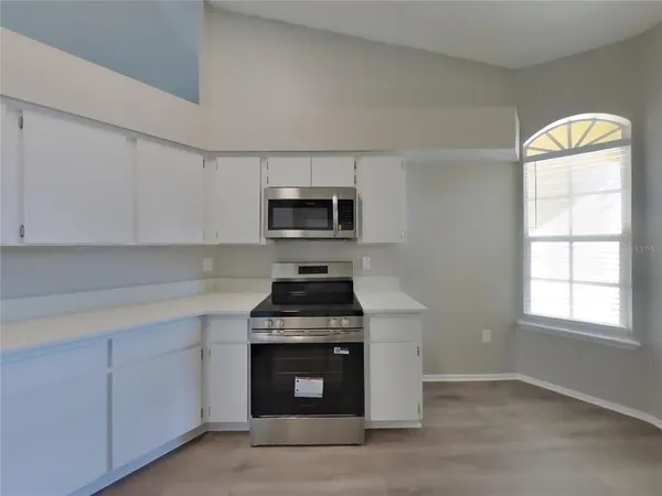 a kitchen with a stove and a microwave