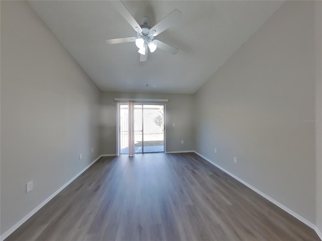 Undisclosed Address Brandon, FL 33511 - Photo 8 of 18 a view of an empty room with wooden floor and a window