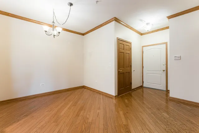 a view of a room with wooden floor and white walls