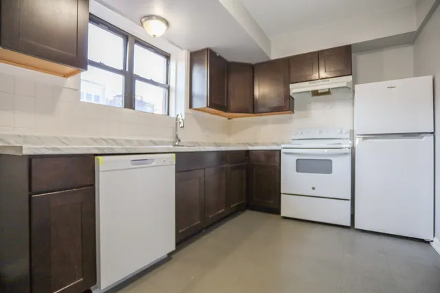 a kitchen with a sink appliances and cabinets