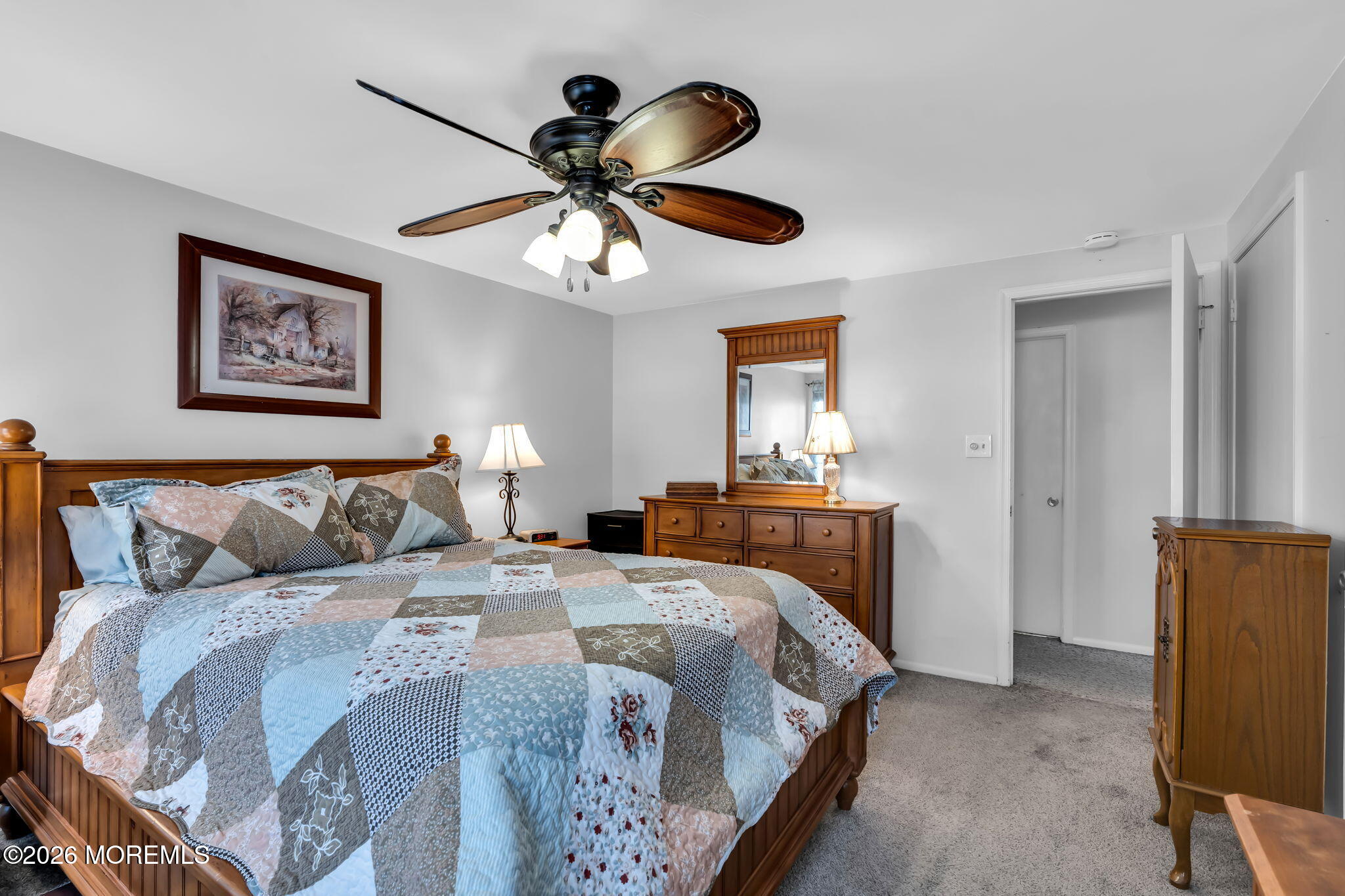 13 Dunbarton Road Jackson, NJ 08527 - Photo 7 of 34 a bedroom with a bed and a chandelier