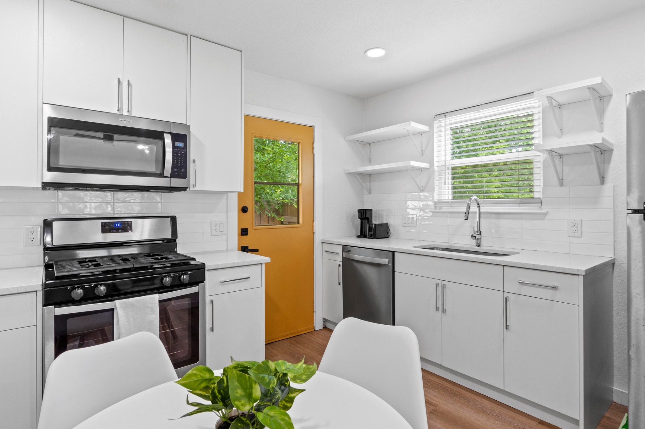 10601 Macmora Road, Unit B Austin, TX 78758 - Photo 9 of 22 A well-appointed kitchen showcasing contemporary cabinetry and essential stainless steel appliances.