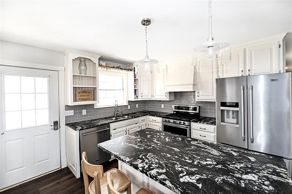 1364 Winn Road Bowie, TX 76230 - Photo 11 of 38 a kitchen with a stove a sink and a refrigerator