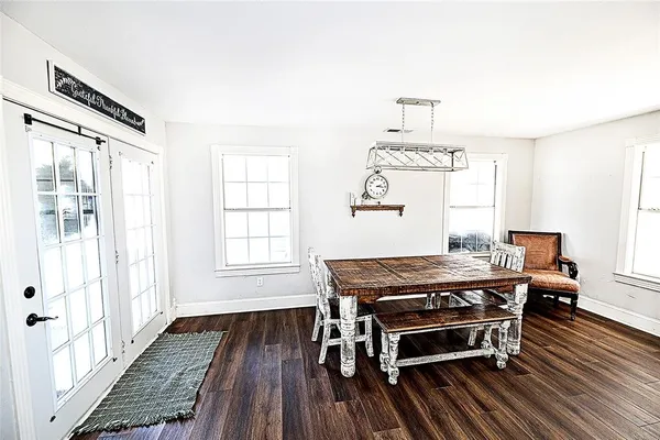 a bedroom with a bed and a mirror on dresser