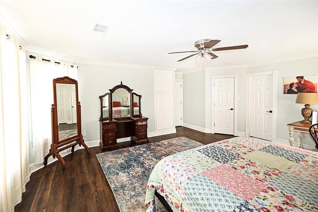1364 Winn Road Bowie, TX 76230 - Photo 19 of 38 a bedroom with a bed and a mirror on dresser