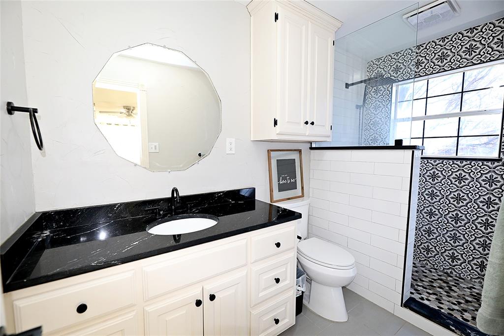 1364 Winn Road Bowie, TX 76230 - Photo 20 of 38 a bathroom with a sink a toilet and a mirror