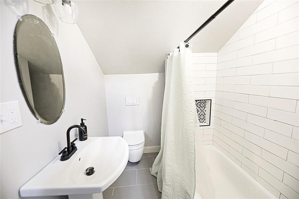 1364 Winn Road Bowie, TX 76230 - Photo 29 of 38 a bathroom with a sink a toilet and shower