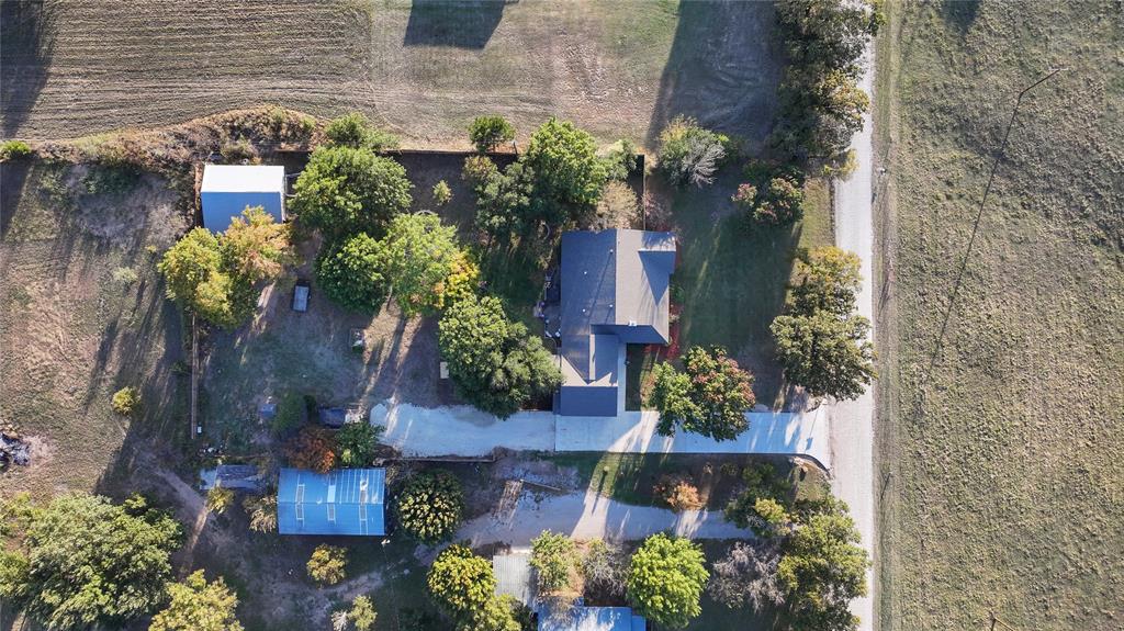 1364 Winn Road Bowie, TX 76230 - Photo 37 of 38 front view of a house with a yard and flowers