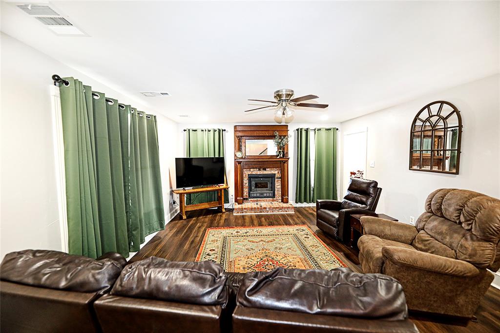 1364 Winn Road Bowie, TX 76230 - Photo 8 of 38 a living room with furniture fireplace and a large window