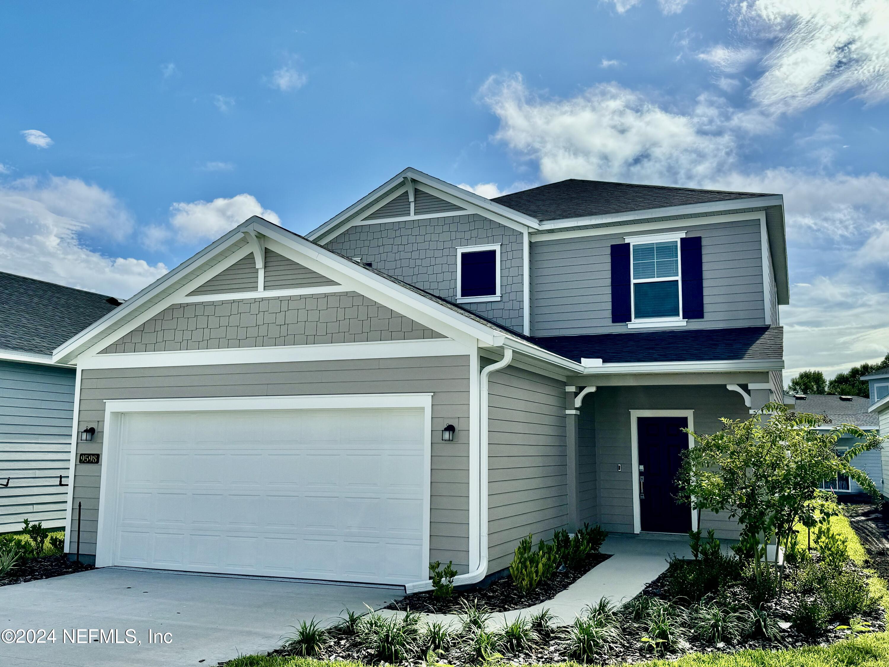 a front view of a house with plants