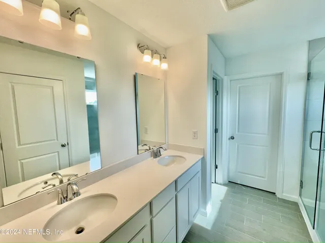 a bathroom with a double vanity sink mirror and double