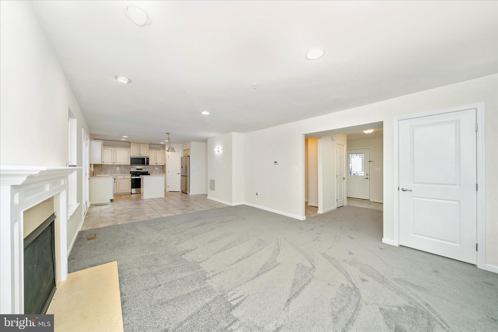 7014 Linden Avenue Elkridge, MD 21075 - Photo 11 of 42 an empty room with a fireplace and window