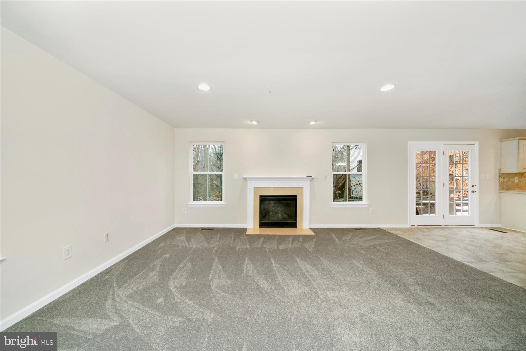 7014 Linden Avenue Elkridge, MD 21075 - Photo 12 of 42 an empty room with windows and fireplace
