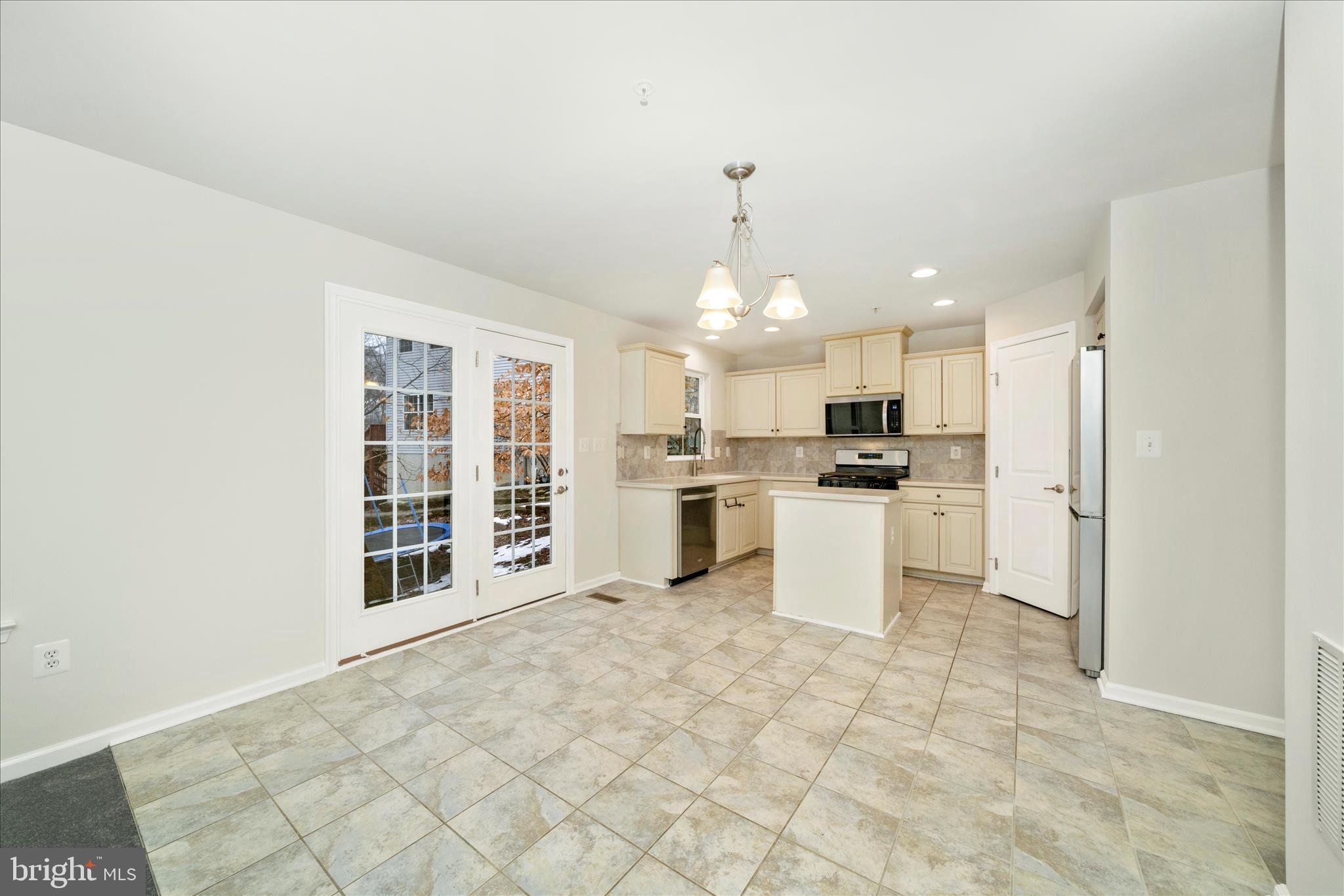 7014 Linden Avenue Elkridge, MD 21075 - Photo 13 of 42 a kitchen with white cabinets and stainless steel appliances