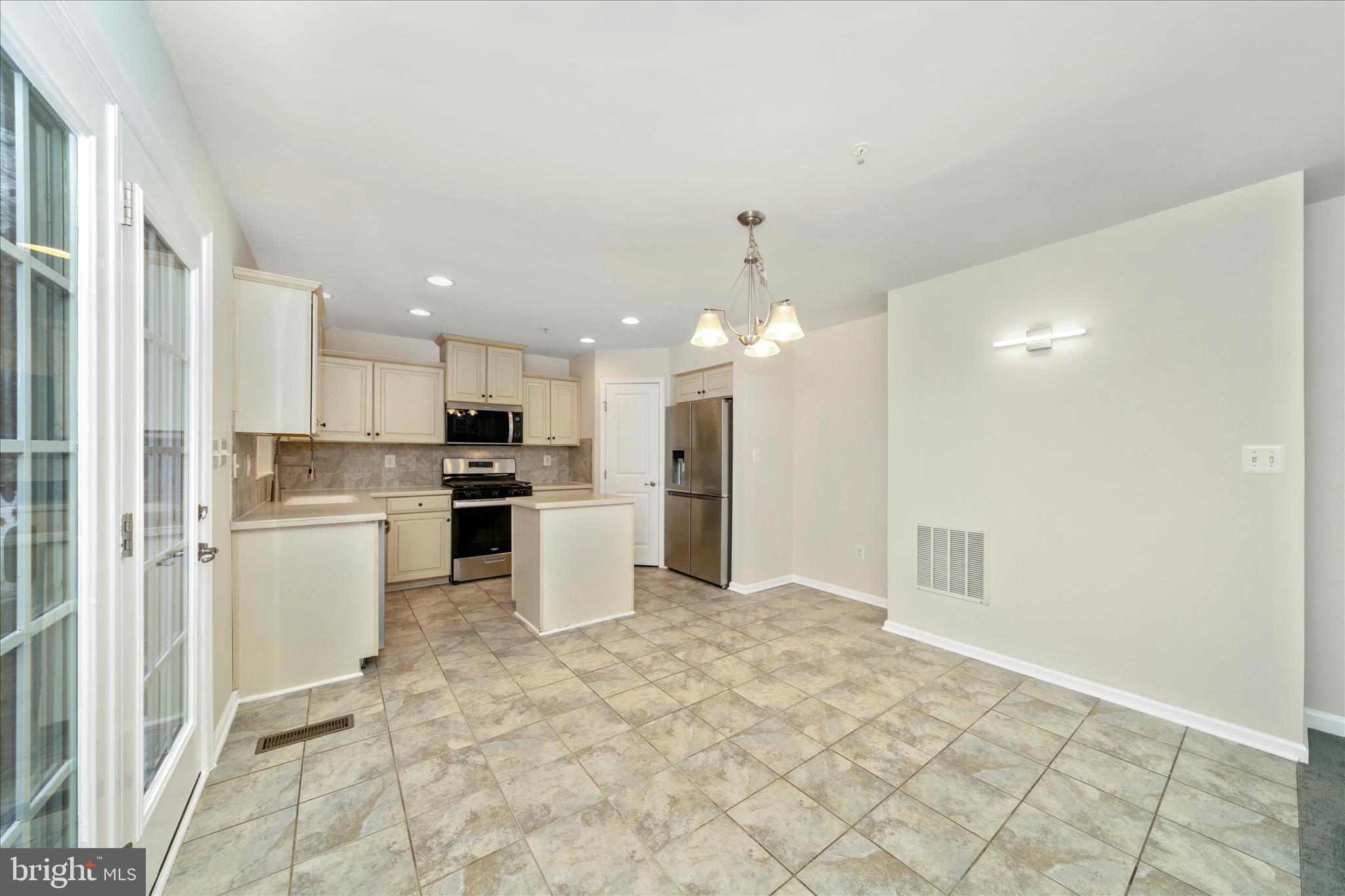 7014 Linden Avenue Elkridge, MD 21075 - Photo 14 of 42 a open kitchen with white cabinets and stainless steel appliances