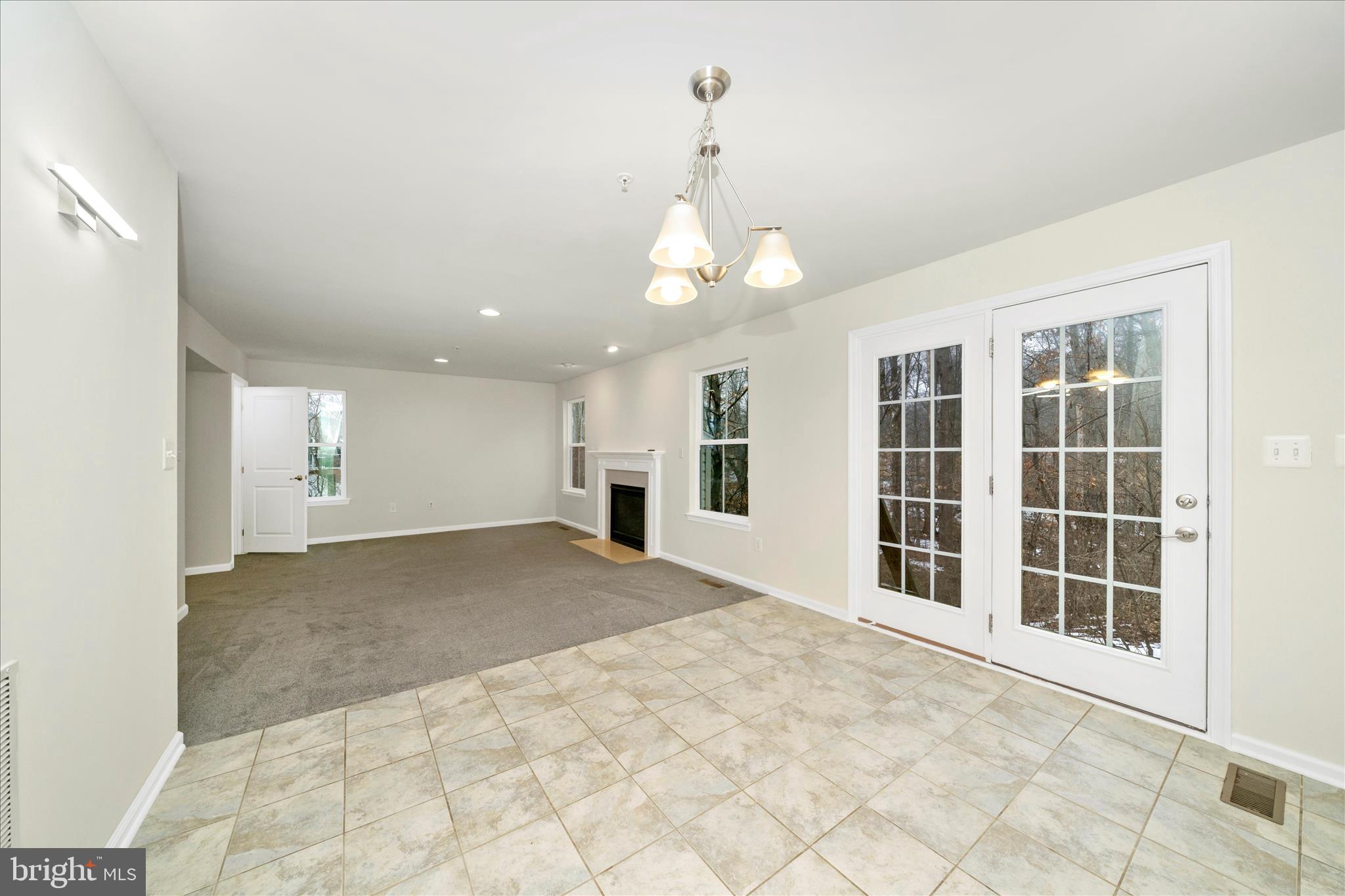 7014 Linden Avenue Elkridge, MD 21075 - Photo 15 of 42 a view of an empty room with a window and kitchen view