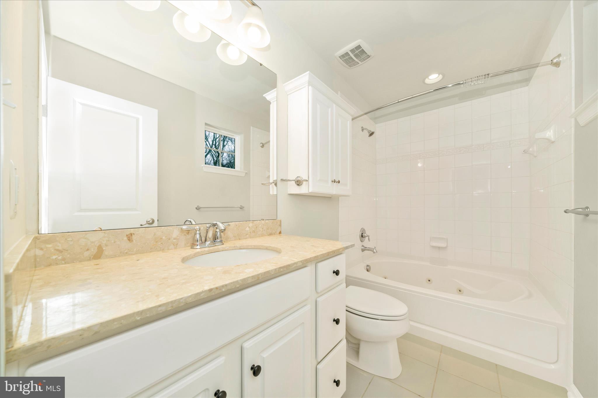 7014 Linden Avenue Elkridge, MD 21075 - Photo 26 of 42 a bathroom with a granite countertop sink a toilet and a bathtub