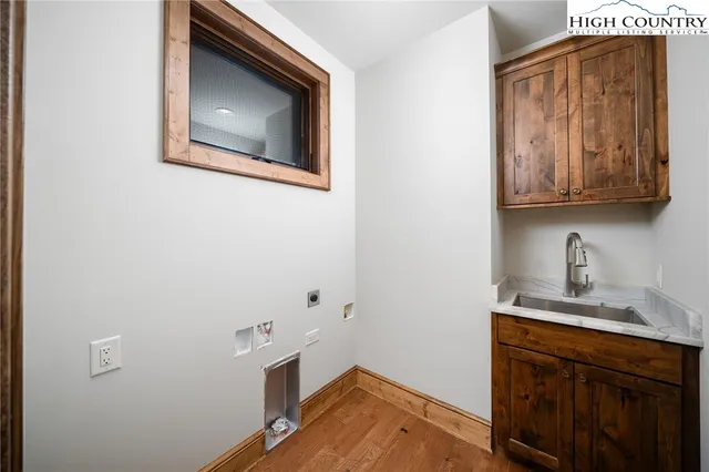 a view of a house with large space and a car parked in front of it