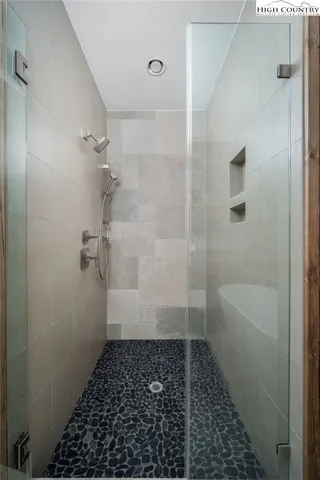 a view of empty room with wooden floor and fireplace