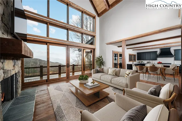 a living room with furniture or couch and a floor to ceiling window