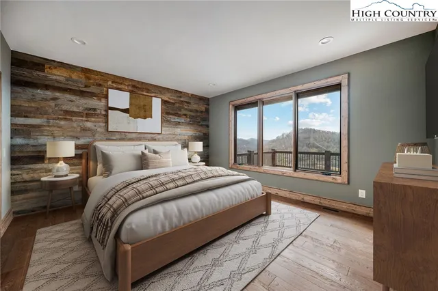 a spacious bedroom with a bed and glass door