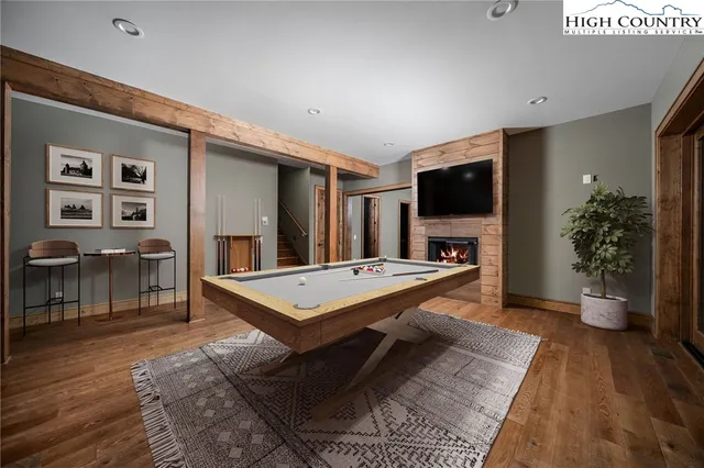 a living room with furniture a flat screen tv and a rug