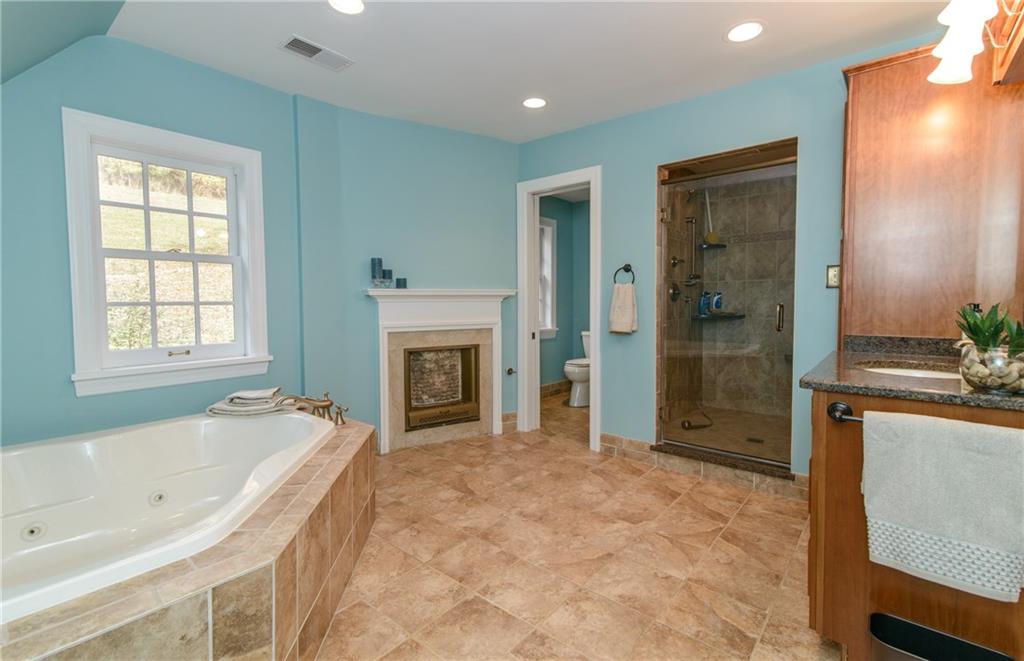 268 Merriman Road Sewickley Heights, PA 15143 - Photo 19 of 25 The Master Bath has a large shower, fireplace, jet spray tub, granite vanity, ceramic tile flooring.