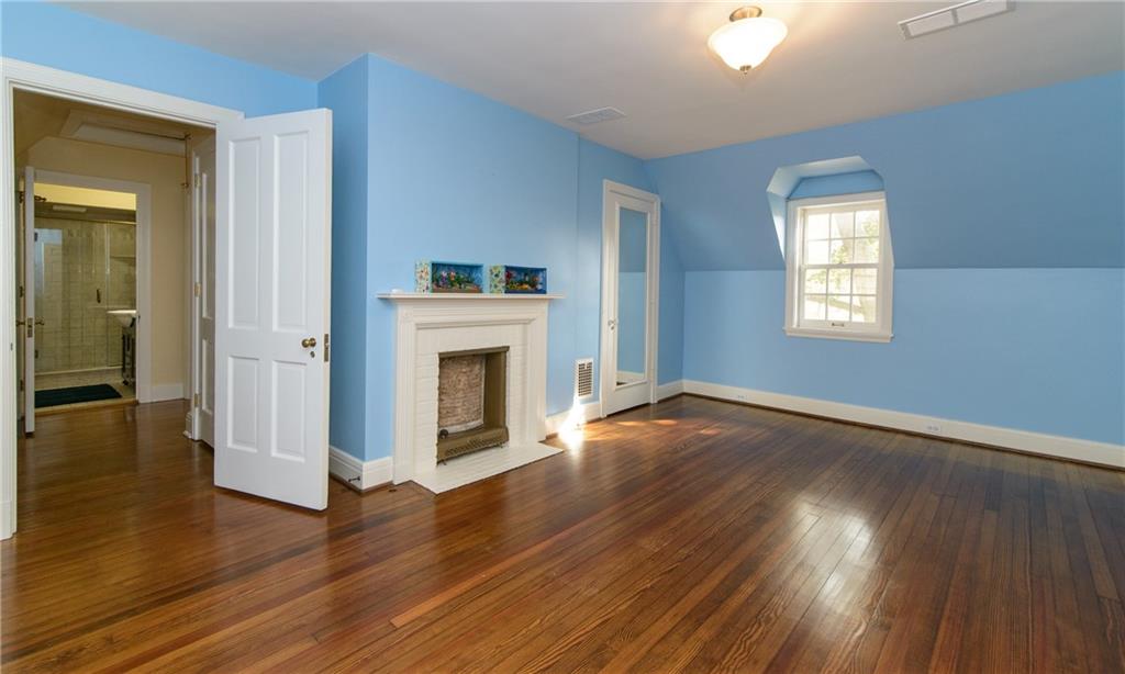 268 Merriman Road Sewickley Heights, PA 15143 - Photo 22 of 25 The fourth bedroom has a fireplace, beautiful flooring, door opens to the hall bath.