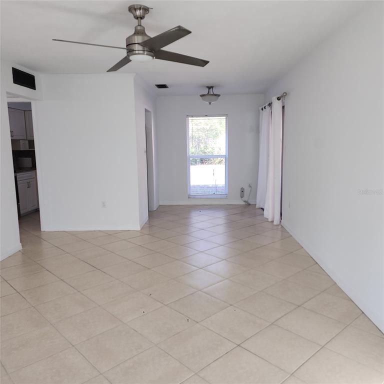 3925 Omega Lane Sarasota, FL 34235 - Photo 11 of 22 a view of a livingroom with a ceiling fan and window
