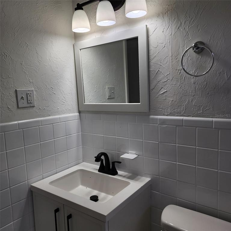 3925 Omega Lane Sarasota, FL 34235 - Photo 13 of 22 a bathroom with a sink a toilet and mirror