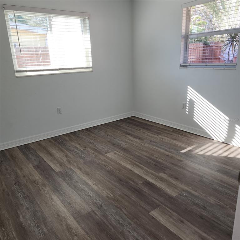 3925 Omega Lane Sarasota, FL 34235 - Photo 14 of 22 a view of an empty room with wooden floor and a window