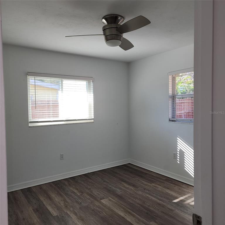 3925 Omega Lane Sarasota, FL 34235 - Photo 16 of 22 a view of an empty room with wooden floor and a window