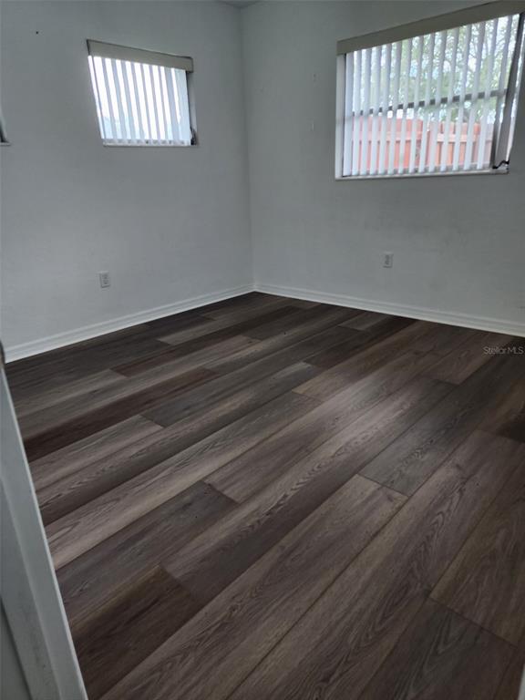 3925 Omega Lane Sarasota, FL 34235 - Photo 17 of 22 a view of wooden floor and window in an empty room