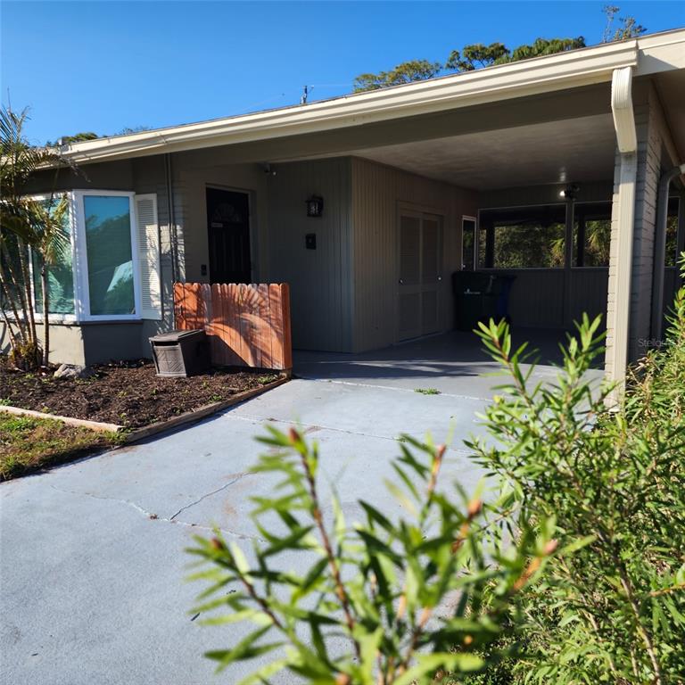 3925 Omega Lane Sarasota, FL 34235 - Photo 2 of 22 a view of the house with potted plants
