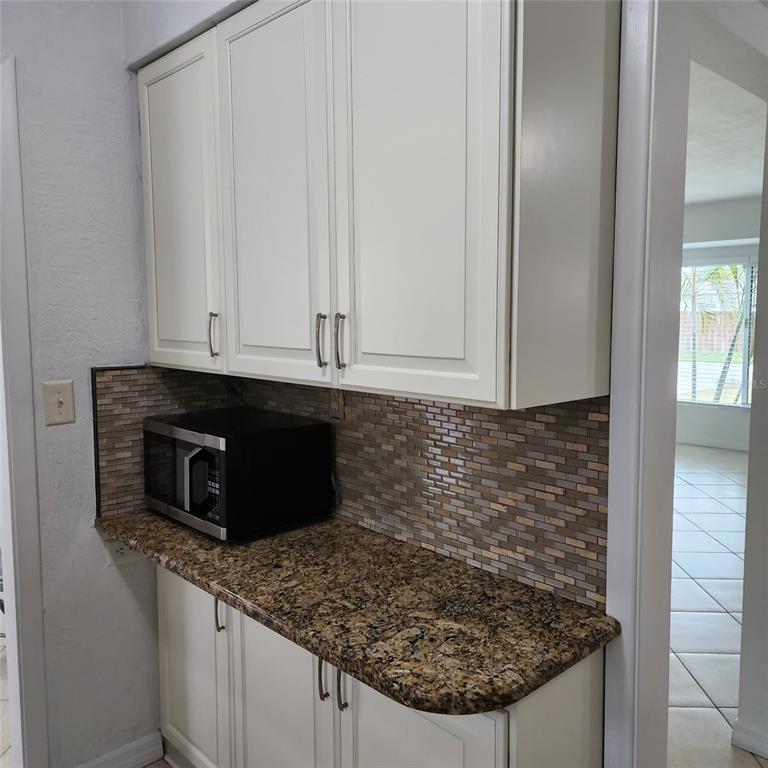 3925 Omega Lane Sarasota, FL 34235 - Photo 6 of 22 a kitchen with granite countertop a sink and a stove