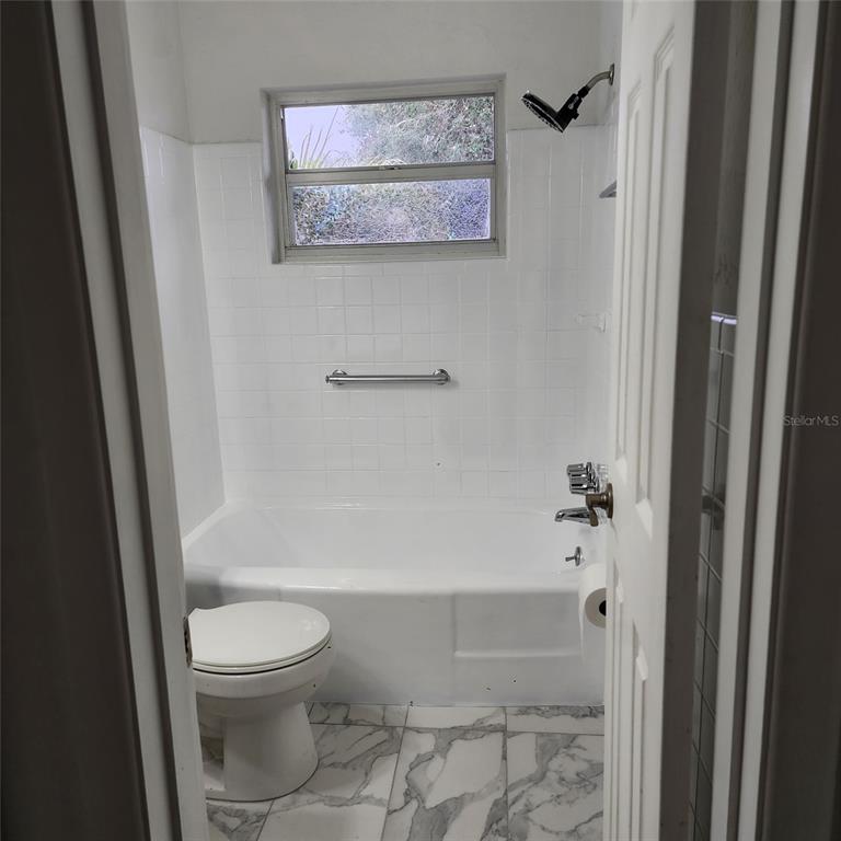 3925 Omega Lane Sarasota, FL 34235 - Photo 7 of 22 a bathroom with a toilet and a shower