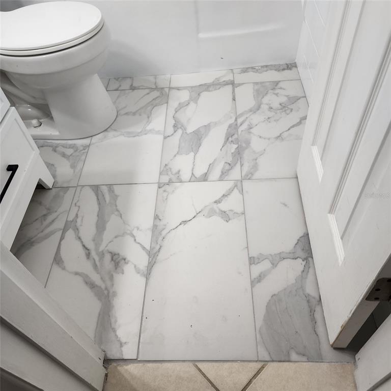 3925 Omega Lane Sarasota, FL 34235 - Photo 8 of 22 a bathroom with a toilet and a shower