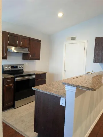 a kitchen with a sink and a stove top oven