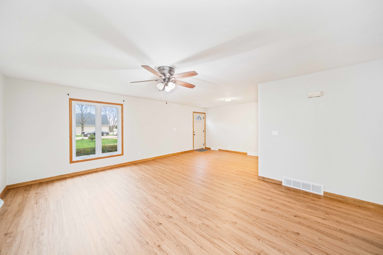 1839 Irene Road Lake Holiday, IL 60548 - Photo 7 of 19 a view of an empty room with wooden floor and a window