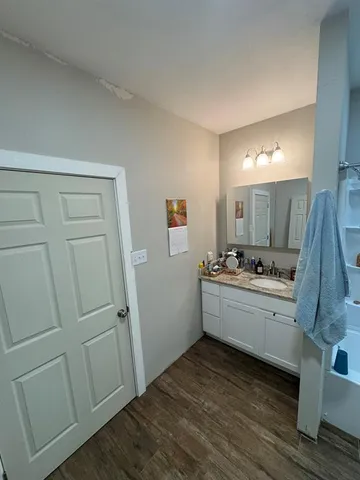 a bathroom with a tub sink a mirror and a shower