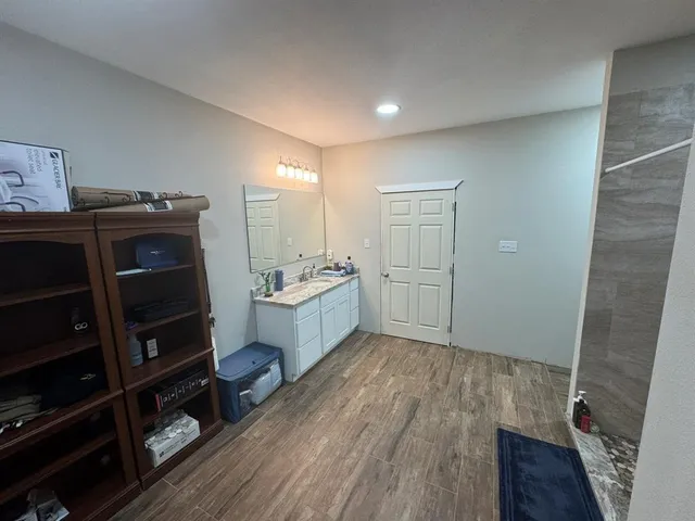 a bedroom with furniture and a wooden floor