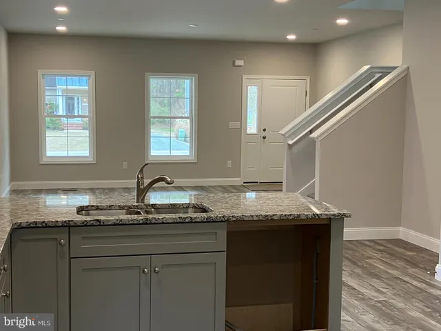 a kitchen with granite countertop a sink and a window