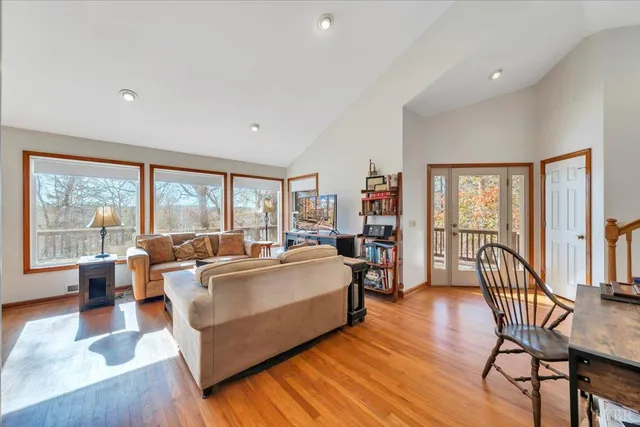a living room with furniture fireplace and a large window