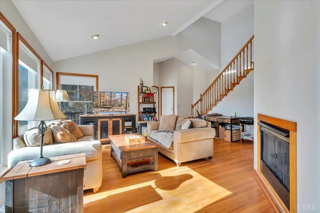 a kitchen with stainless steel appliances granite countertop a stove top oven a sink dishwasher a dining table and chairs with wooden floor