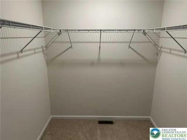 a white toilet sitting next to a small window