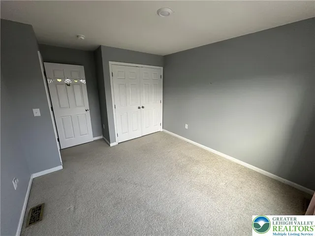 an empty room with a empty space and windows