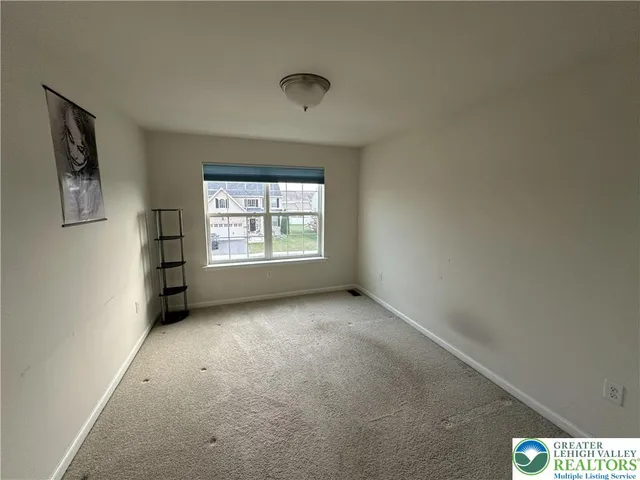 a view of an empty room and a window