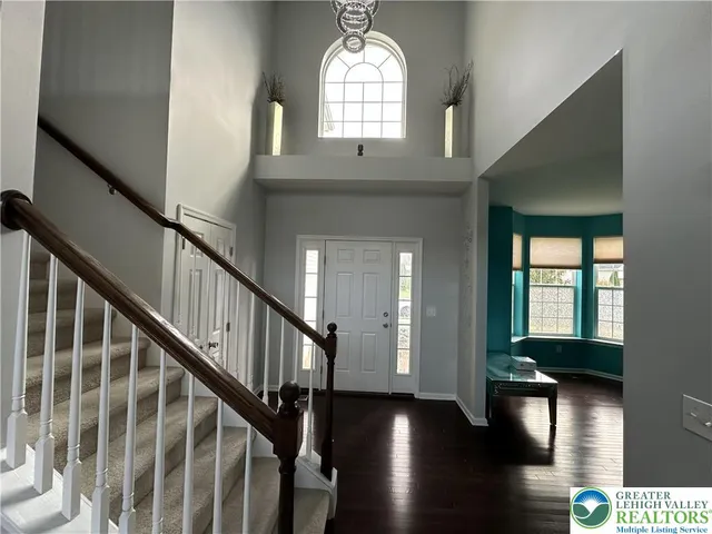 a view of entryway and hall with wooden floor